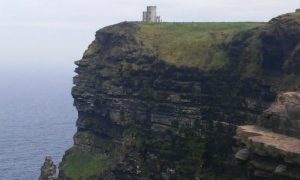 Ireland 101: Image of the stone turrett at the Cliffs of Moher.