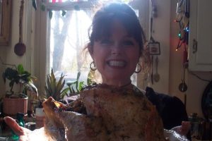Thanksgiving Story: image of woman with a roasted turkey