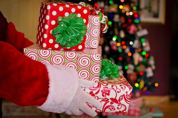A trio of Santa Claus Tales: Image of Santa's hands with presents.