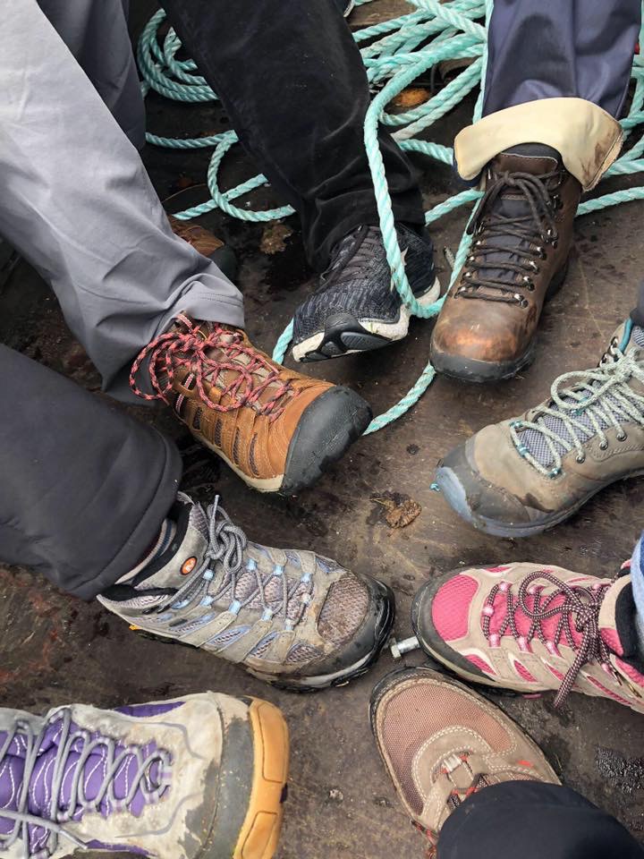 Scotland Revisited: image of seven hiking boots in a circle.